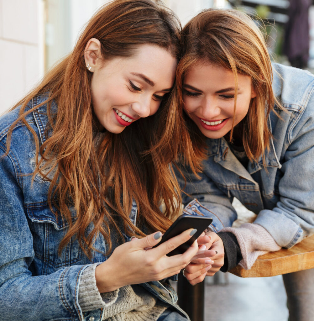 Two women looking at a phone